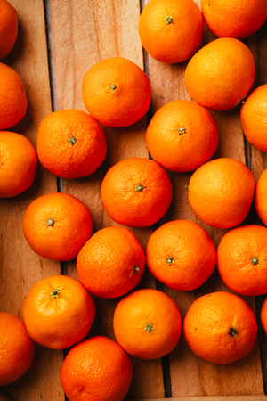 many fresh tangerines  on a wooden backgroundの写真素材