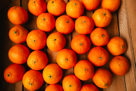 many fresh tangerines  on a wooden backgroundの写真素材