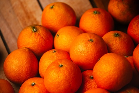 many fresh tangerines  on a wooden backgroundの写真素材