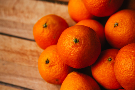 many fresh tangerines  on a wooden backgroundの写真素材