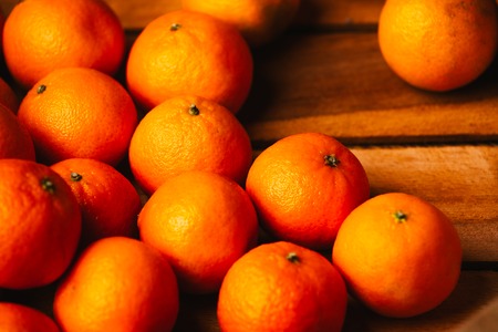 many fresh tangerines  on a wooden backgroundの写真素材