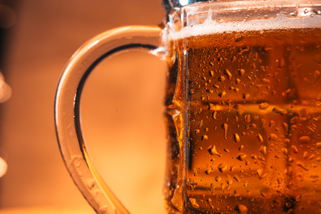 close-up mug of light beer on a blurred  backgroundの写真素材