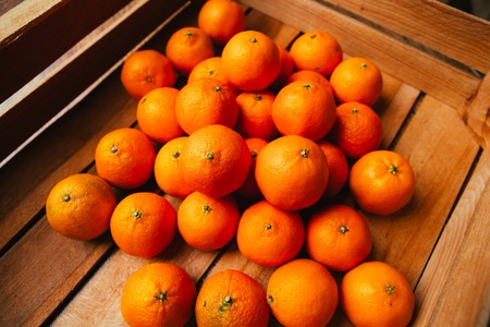 Fresh fruit  tangerines in a wooden boxの写真素材
