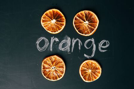 four cup sliced orange on a black background  board