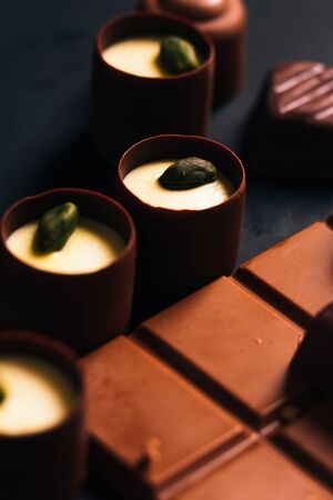 Many chocolate sweets with Pistachio on black backgroundの写真素材