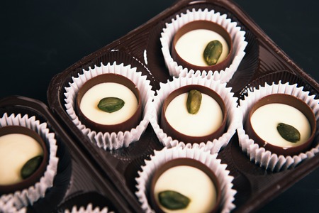 Many chocolate sweets with Pistachio on black backgroundの写真素材
