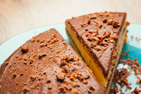 sweet cake and chocolate chips on a blue  plateの写真素材