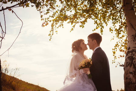 young bride and groom on the  background of the lakeの写真素材