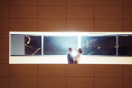 bride and  groom on the background of the hotelの写真素材