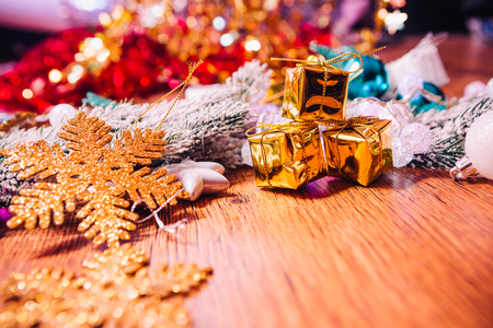 Spruce branches in the  snow gold and white christmas decoration on wooden backgroundの写真素材
