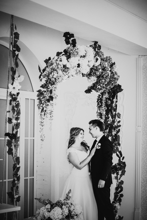 Black white photography  bride and groom posing  in a hotel roomの写真素材