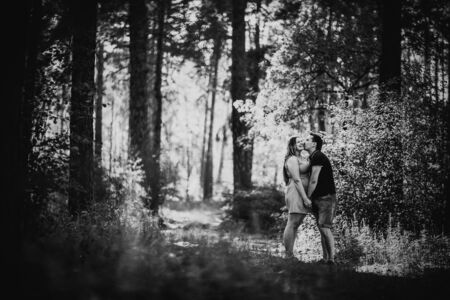 Black white photography romantic young couple kissing  on background summer forestの写真素材