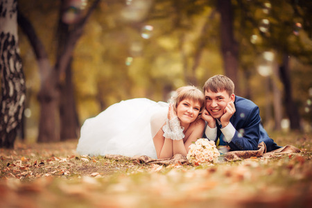 young bride and groom  on the background of the autumn landscapeの写真素材