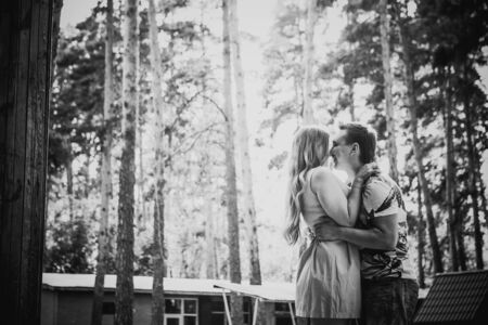 Black white photography  romantic young couple kissing  on background summer forestの写真素材