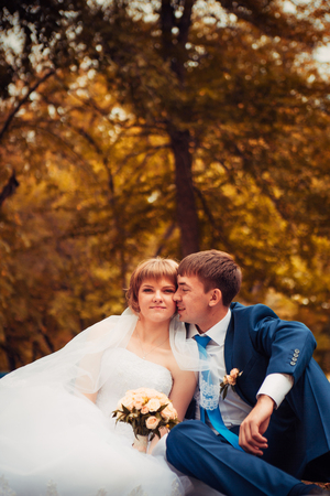 young bride and groom  on the background of the autumn landscapeの写真素材