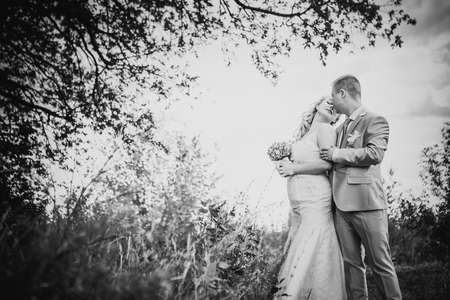 Black white  photography  beautiful wedding young couple stand on  background forestの写真素材