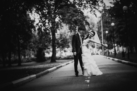 Black white photography beautiful young couple stand on  background forestの写真素材