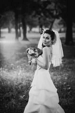 Black white photography beautiful young bride stand on  background forestの写真素材