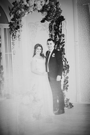 Black white photography  bride and groom posing  in a hotel roomの写真素材