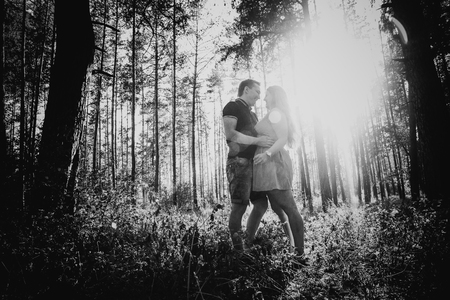 Black white photography romantic young couple kissing  on background summer forestの写真素材