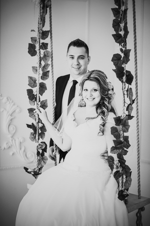 Black white photography  bride and groom posing  in a hotel roomの写真素材