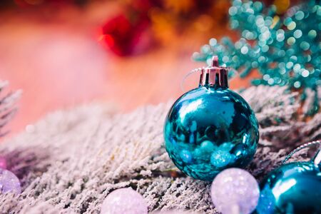 Spruce branches in the snow,  and blue balls wooden backgroundの写真素材