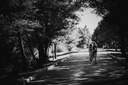 Black white photography  romantic young couple kissing  on background summer forestの写真素材
