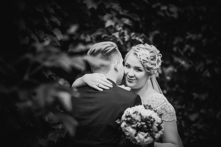 Black white  photography beautiful young couple stand on  background forestの写真素材