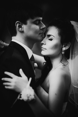 Black white photography  wedding beautiful young couple stand on background forestの写真素材