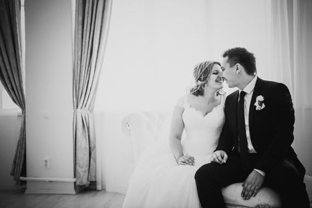 Black white photography  bride and groom posing  in a hotel roomの写真素材