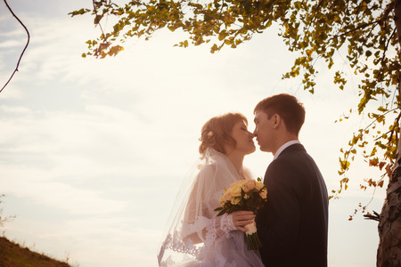 young bride and groom on the  background of the lakeの写真素材