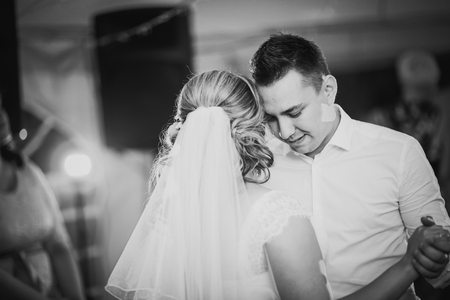 Black white  photography beautiful touching first dance of the  bride and groomの写真素材