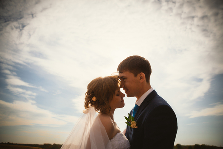 young  bride and groom on the background skyの写真素材