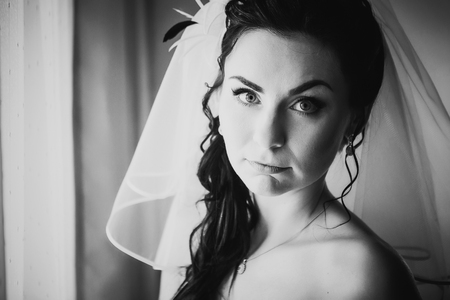 Black white photography beautiful young bride  costs about stylish windowの写真素材