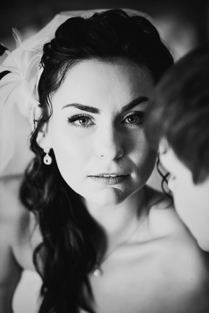 Black white photography beautiful young  couple standing near the windowの写真素材