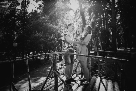 Black white photography  romantic young couple kissing  and stand to bridge on backgroundの写真素材