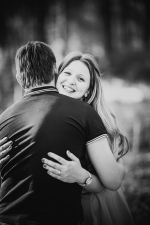Black white photography romantic young couple kissing  on background summer forestの写真素材
