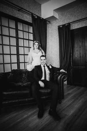 Black white photography bride and groom posing  in a hotel roomの写真素材