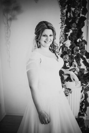 Black white photography  elegance cute  bride is posing on the  background roomの写真素材