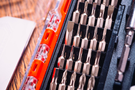 set of nozzles for screwdriver  in red box on wooden backgroundの写真素材
