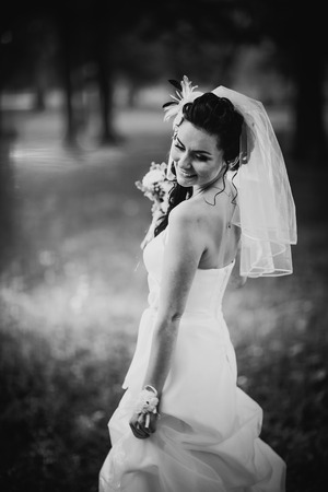 Black white photography beautiful young bride stand on  background forestの写真素材