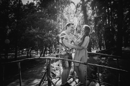 Black white photography  romantic young couple kissing  and stand to bridge on backgroundの写真素材