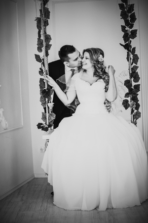 Black white photography bride and groom posing  in a hotel roomの写真素材