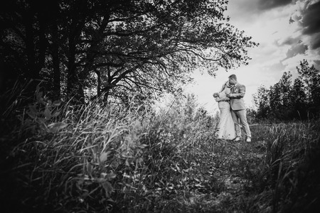 Black white  photography  beautiful wedding young couple stand on  background forestの写真素材