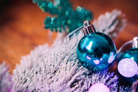 Spruce branches in the  snow violet blue and white christmas balls on dark wooden backgroundの写真素材