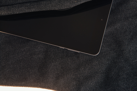 Tablet computer is on the dark bag on a  white backgroundの写真素材