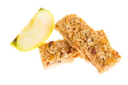 muesli bars with dried fruit on isolated background with  appleの写真素材