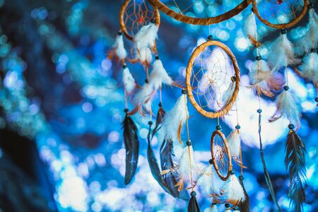 Dreamcatcher against a white blur of snow.の写真素材