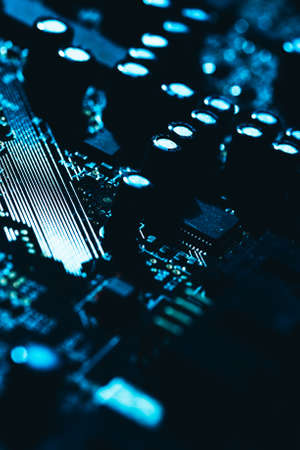 computer motherboard in blue dark background close-up.の写真素材