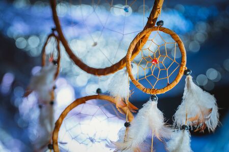 Dreamcatcher against a white blur of snow.の写真素材
